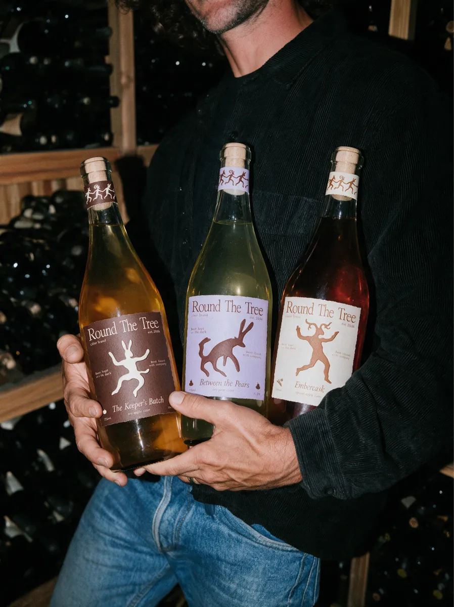 Three Round The Tree bottles in a cellar